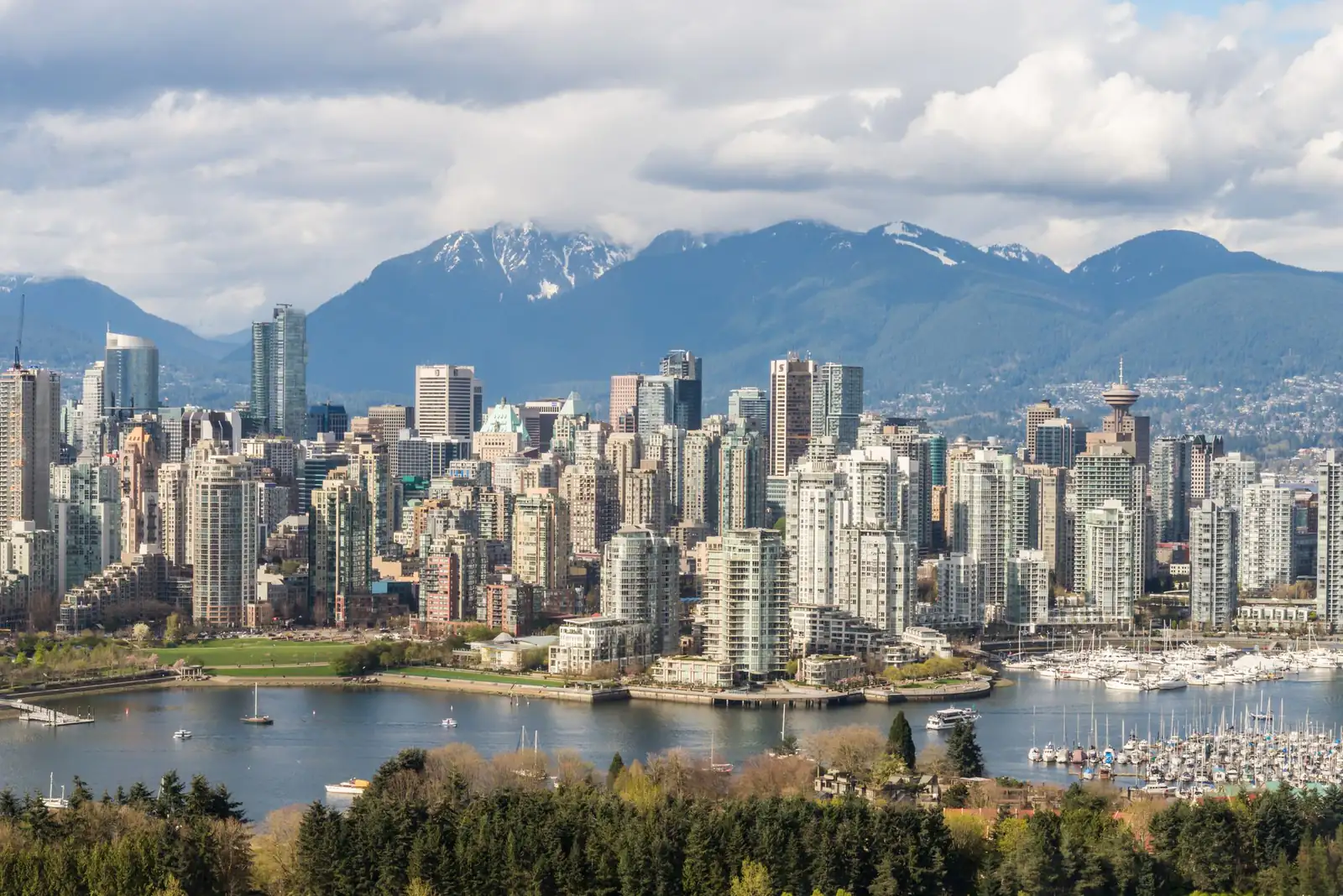 Downtown Vancouver’s towers and False Creek marina beneath the snow-capped North Shore mountains